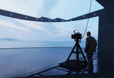 Virtual production studio with a curved LED wall and camera rig on tracking rails